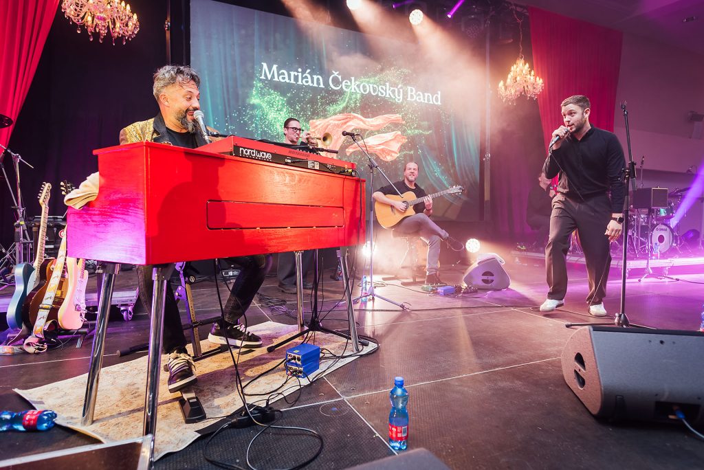 Členovia Marián Čekovský Band počas vystúpenia, v popredí červené klávesy